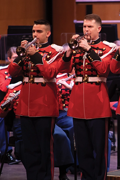 Two trumpeters in red performing on stage