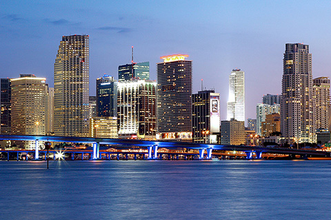 A shot of the Miami Skyline including water and bridges at the fore front