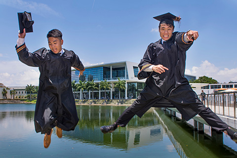 Newly graduated students jumping in the air at the University of Miami
